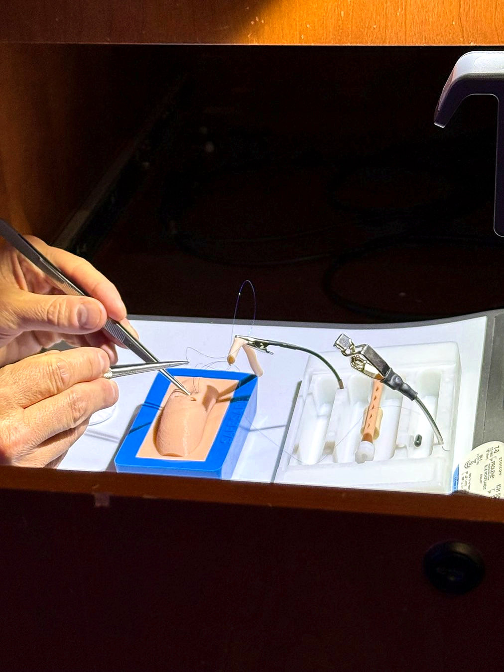 Close-up of real surgical tools and synthetic practice model