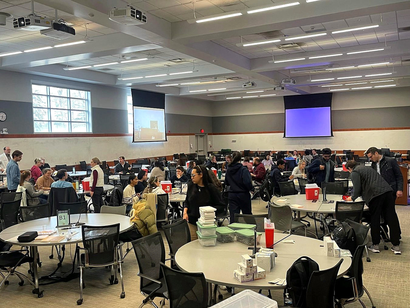A large group engaged in hands-on surgical skills practice